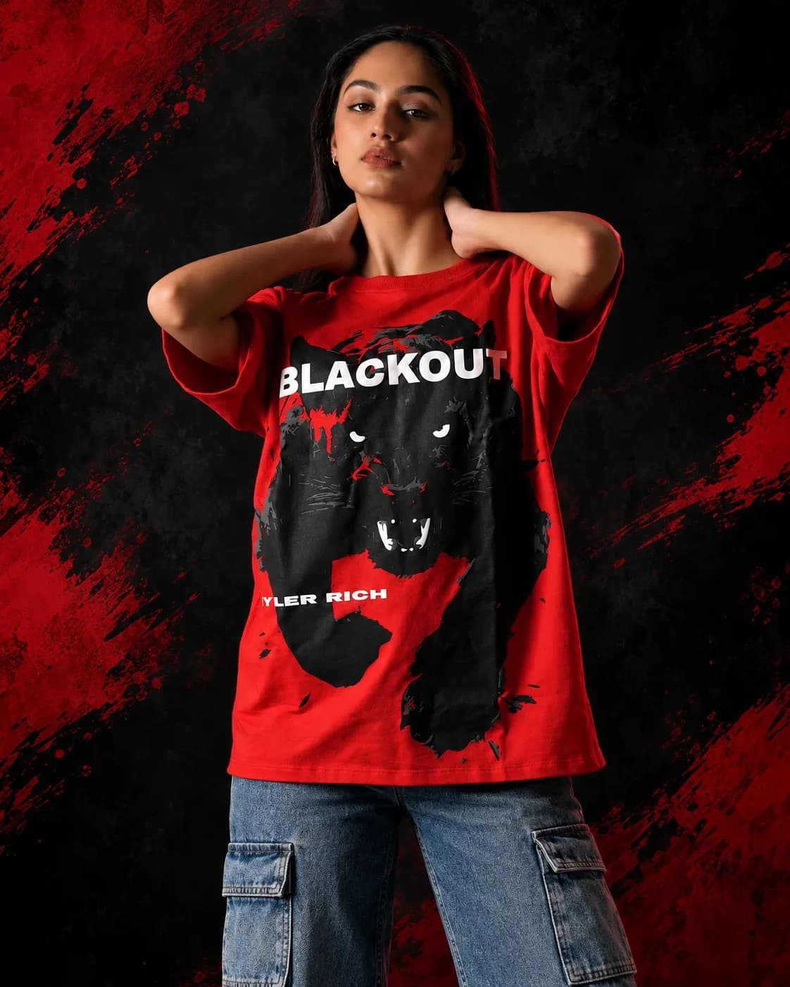 Model wearing the red Red Blackout oversized panther graphic T-shirt against a black background with red brush accents.